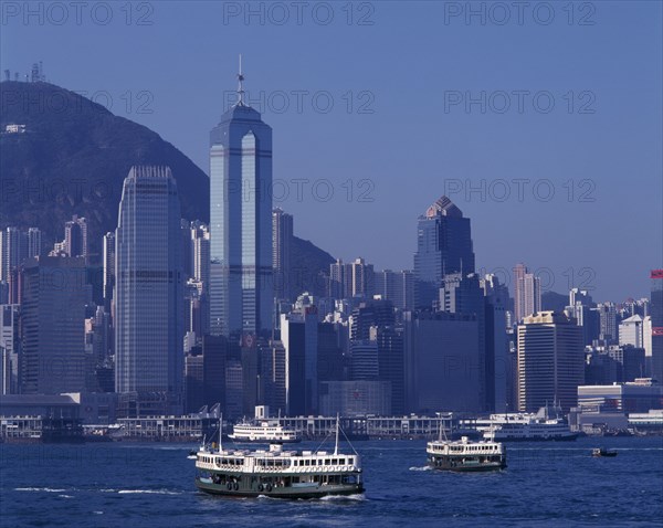 HONG KONG, Victoria Harbour, Star Ferries sailing away from the city skyline behind