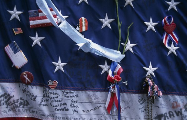 USA, New York, New York City, Close up detail of September 11th memorial with decorated stars and stripes flag