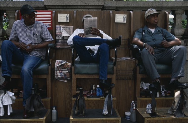 USA, New York, New York City, Shoe shiners relaxing in their chairs
