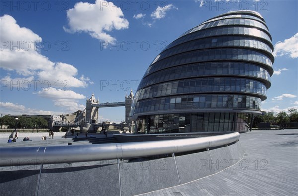 ENGLAND, London, "City Hall, exterior view of the curved architecture with Tower Bridge in the distance"