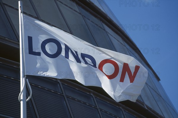 ENGLAND, London, City Hall, White flag with the word London written in red and blue letters flying in front of the curved architecture