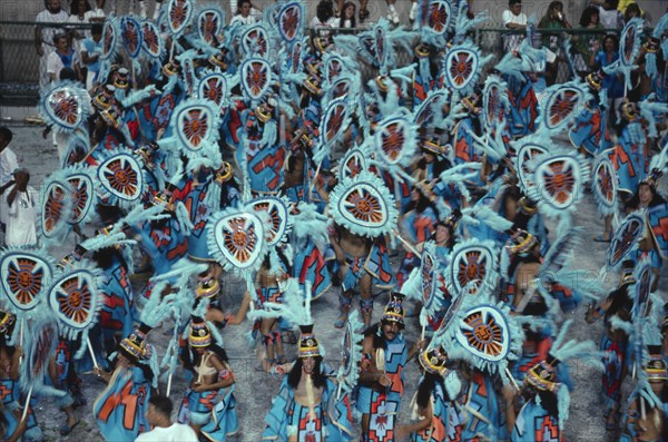 BRAZIL, Rio de Janeiro, Carnival procession of dancers dressed in feathered costumes
