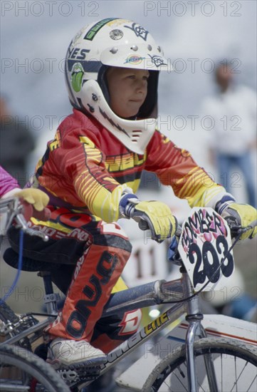 20025488 SPORT Bicycles BMX Young boy sitting on his bike ready for the start of a race