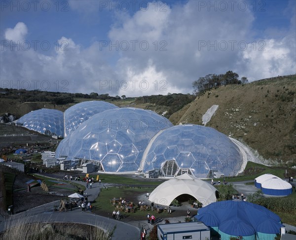 ENGLAND, Cornwall, St Austell, Eden Project. View over temperate domes with tropical domes behind