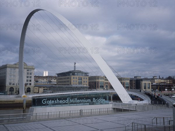 ENGLAND, Tyne and Wear, Gateshead, Millennium Bridge. Large white arch with suspended platform over the River Tyne