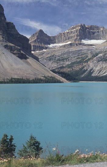 CANADA, British Columbia, Jasper National Park, View over mountain lake toward rocky cliffs