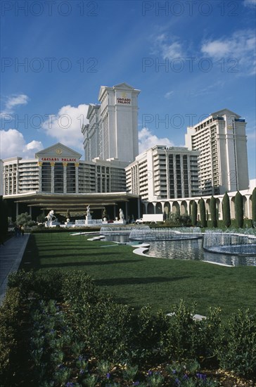 USA, Nevada, Las Vegas, Caesar’s Palace hotel and casino with lawns and fountains in the foreground