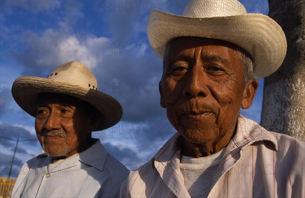 20026145 MEXICO Yucatan Hoctún Two smiling  elderly men in hats  head and shoulders portraits one slightly behind other.