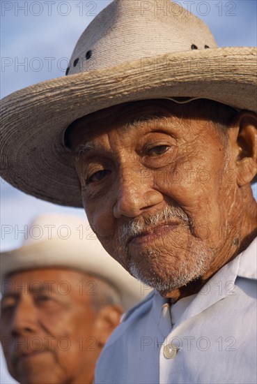 MEXICO, Yucatan, Hoctun, "Two smiling, elderly men in hats, head and shoulders portraits one only part seen in background. "