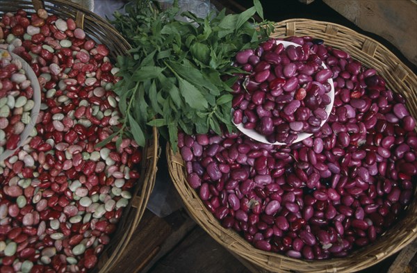 MEXICO, Chiapas, San Cristobal de Las Casas, "Pink, white and red shelled beans displayed in shallow baskets."