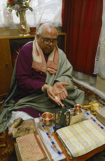 ENGLAND, Religion, Hindu, Priest making food offering to the gods.