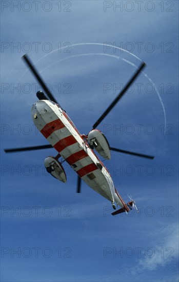 SCOTLAND, North Sea, Murchison Oil Field, "Helicopter hovering, seen from below with red and white striped undercarriage."