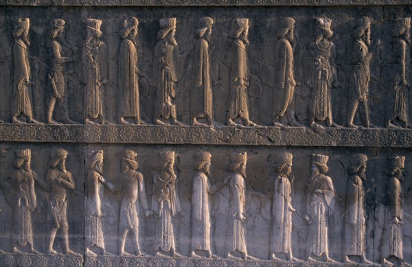 IRAN, South, Persepolis, Fifth century BC Archaemenid palace complex.  Detail of relief carving on the eastern section of the Apadana stairway depicting diginitaries of the realm paying tribute.