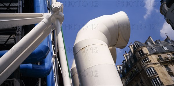 FRANCE, Ile de France, Paris, "Pompidou Centre.  Part view of industrial style exterior with older, traditional building behind. "