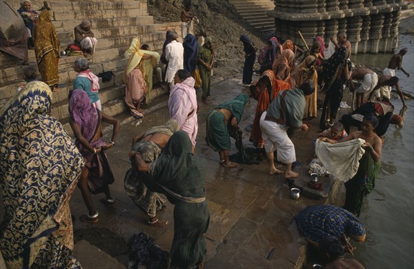 INDIA, Uttar Pradesh, Varanasi, People gathered on the ghats and bathing in the River Ganges