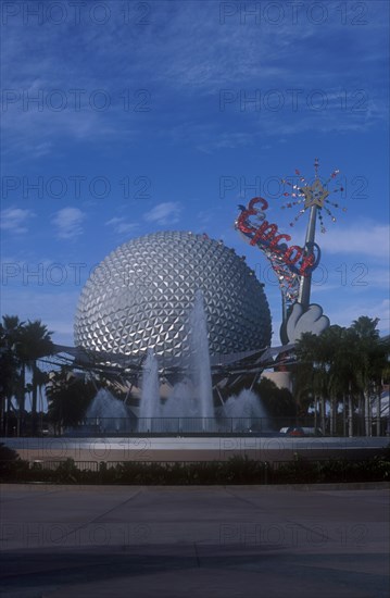USA, Florida, Orlando, Walt Disney World Epcot. View of the Spaceship Earth with sparkling red Epcot sign and fountain at the base.