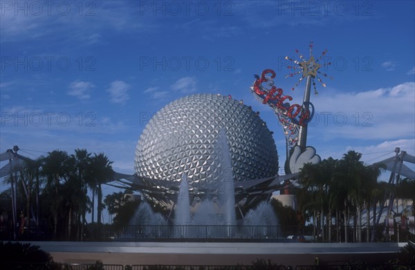 USA, Florida, Orlando, Walt Disney World Epcot. View of the Spaceship Earth with sparkling red Epcot sign and fountain at the base.