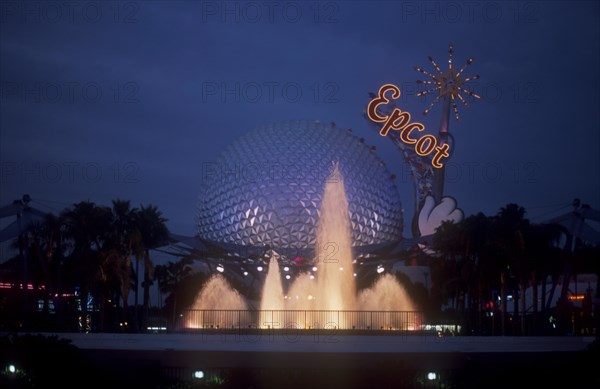 USA, Florida, Orlando, Walt Disney World Epcot. View of the Spaceship Earth with  Epcot sign and fountain illuminated at dusk.
