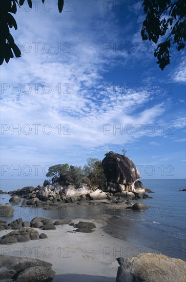 MALAYSIA, Penang, Batu Ferringhi, Batu Ferringhi or Foreigners Rock rising out of shallow water beside beach of the same name.