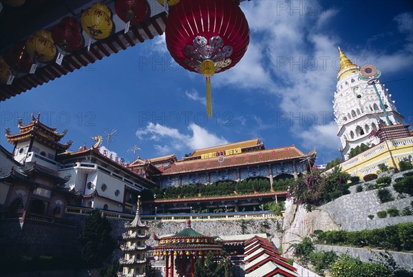 MALAYSIA, Penang, Kek Lok Si Temple, "General view of the temple complex with Ban Po, the Pagoda of a Thousand Buddhas on the right. Part framed by overhanging roof with red Chinese lantern "