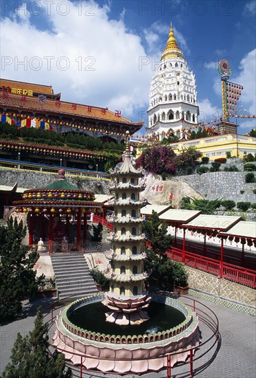 MALAYSIA, Penang, Kek Lok Si Temple, "General view of temple complex with Ban Po, the Pagoda of a Thousand Buddhas in background and circular pond with seven tiered pagoda sculpture in centre in front."