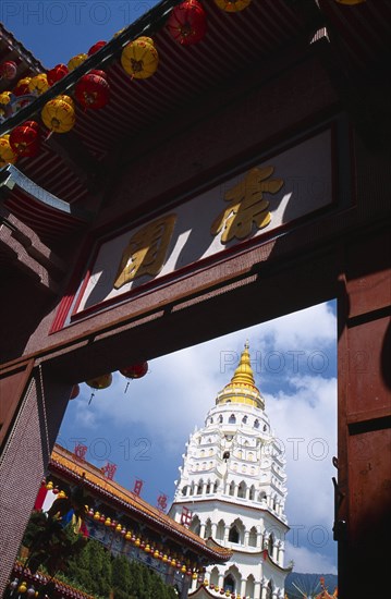 MALAYSIA, Penang, Kek Lok Si Temple, "Ban Po, the Pagoda of a Thousand Buddhas framed by doorway with Chinese letters above and red and yellow Chinese lanterns strung along overhanging roof."