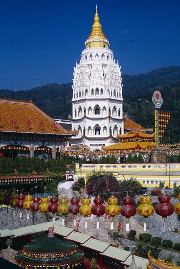 MALAYSIA, Penang, Kek Lok Si Temple, "General view of temple complex and Ban Po, the Pagoda of a Thousand Buddhas with string of red and yellow Chinese lanterns in the foreground."
