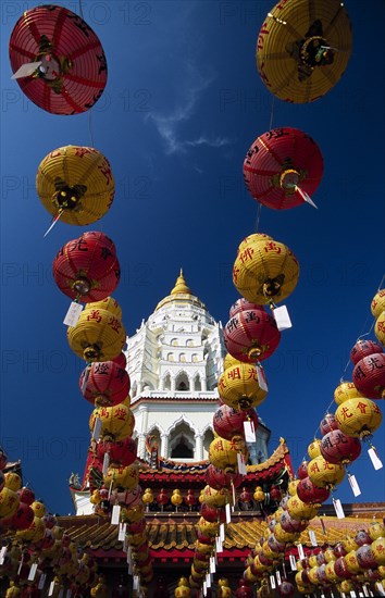 MALAYSIA, Penang, Kek Lok Si Temple, "Ban Po, the Pagoda of a Thousand Buddhas seen between strings of red and yellow coloured Chinese New Year lanterns. "