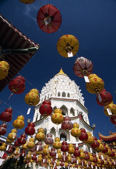 MALAYSIA, Penang, Kek Lok Si Temple, "Ban Po, the Pagoda of a Thousand Buddhas seen between strings of red and yellow coloured Chinese New Year lanterns. "