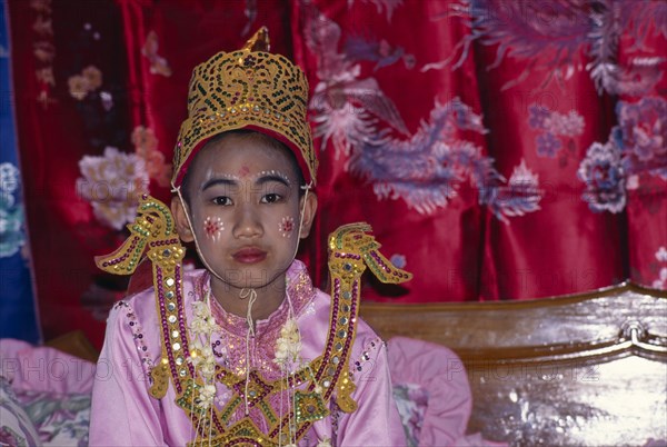 THAILAND, Religion , Buddhism, Novice monk ordination with boy in pink and gold costume and face paint