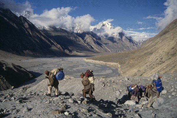 10000752 PAKISTAN  Terminal Moraine  Porters climbing in Balforo Glacier National Park