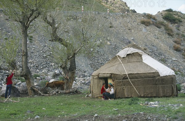 CHINA, Xinjiang , Tianchi, "Kazakh Yurt, tent, with women and young boy outside"