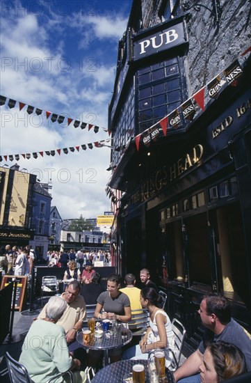 IRELAND, County Galway , Galway, People sitting outside Kings Head pub on Quay Street