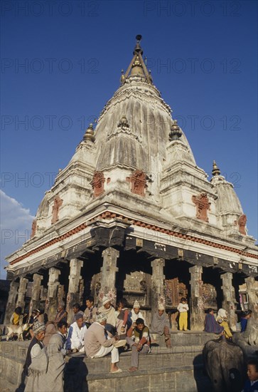 NEPAL, Religious, Bungamati Temple exterior with people gathered on the steps and golden spire above