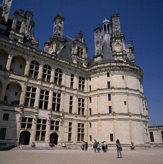 FRANCE, Loire Valley, Loir et Cher, Chambord Chateau. Tourists on gravelled entrance near round tower