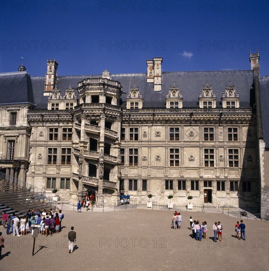 FRANCE, Loire Valley, Loir et Cher, Blois Chateau. Tourists at entrance with circular external staircase