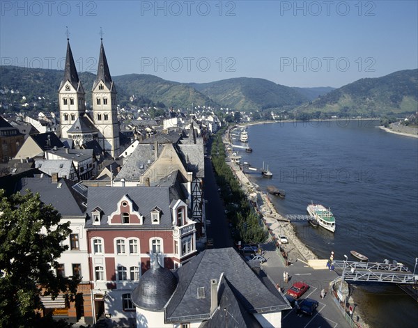 GERMANY, Rhineland, Boppard, Town beside River Rhine. Building with twin towers. Boats moored at pontoons.