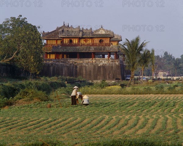 VIETNAM, Central, Hue, "The Citadel, Ngo Mon Gate, workers tending crops in field, trees "