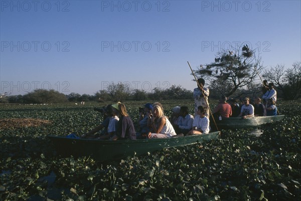 INDIA, Rajasthan, Bharatpur Reserve, Tourisrts in two boats on bird watching tour