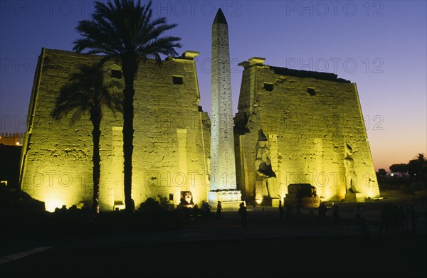 EGYPT, Upper Egypt, Luxor, The Temple Pylons with Obelisk and statues of Ramesses II illuminated at night