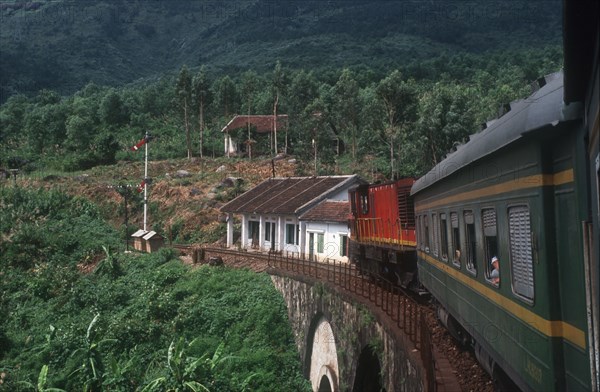 VIETNAM, Hai Van Pass , View from train along carriages as it crosses a bridge surrounded by lush vegetation