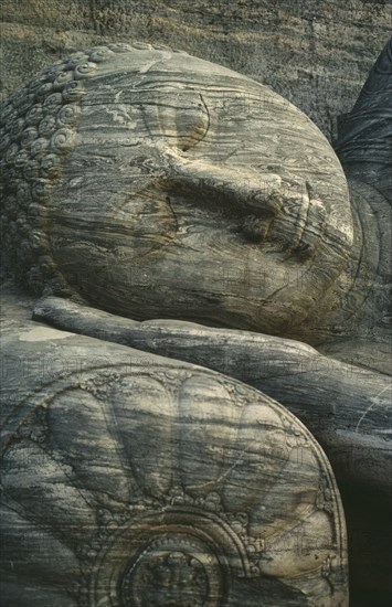 SRI LANKA, Polonnaruwa, Stone carved reclining Buddha detail of head lying on hand