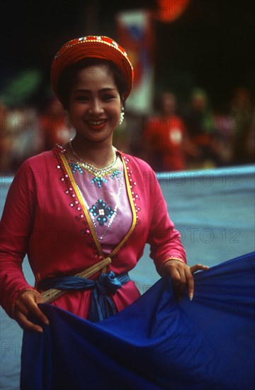 VIETNAM, Hanoi, "Young woman at National Day celebrations, threequarter body shot."