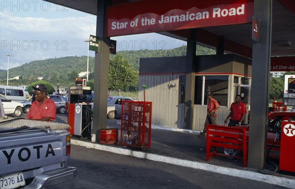 WEST INDIES, Jamaica, Montego Bay, Star Of The Jamaican Road petrol station with attendant filling Toyota pick-up truck.