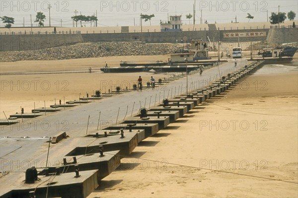 CHINA, Shandong, Jinan, Floating pontoon bridge crossing dry bed of the Yellow River after water has been taken for irrigation.