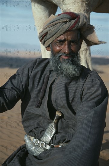 OMAN, Wahiba Sands, People, "Man wearing a khanjar, a traditional curved dagger attached to his belt."