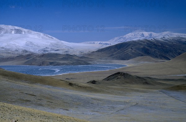 MONGOLIA, Bayan Olgii Province, Partially frozen lake by Deluun on the Steppes