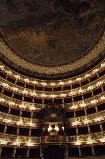 ITALY, Campania, Naples, Teatro San Carlo opera house interior with painted ceiling and ornate balcony boxes.