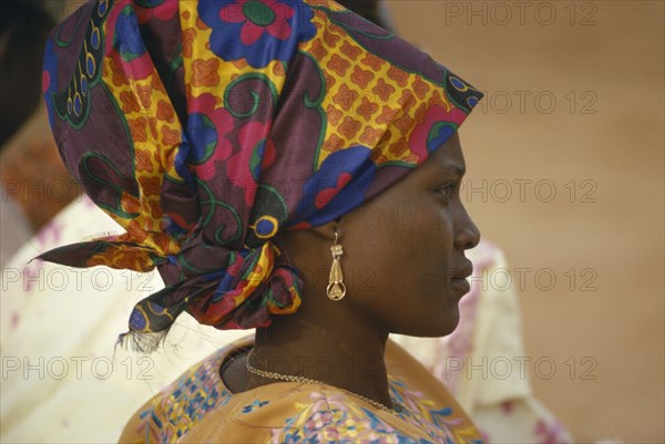 NIGERIA, Traditional Dress, Hausa woman in traditional head dress.  Head and shoulders portrait profile right.