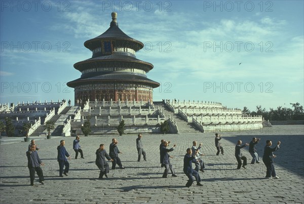 CHINA, Hebei, Beijing, Men doing Tai Chi in front of the Hall of Prayer for Good Harvests at the Temple Of Heaven complex